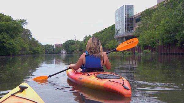 A woman in a kayak in the Chicago River